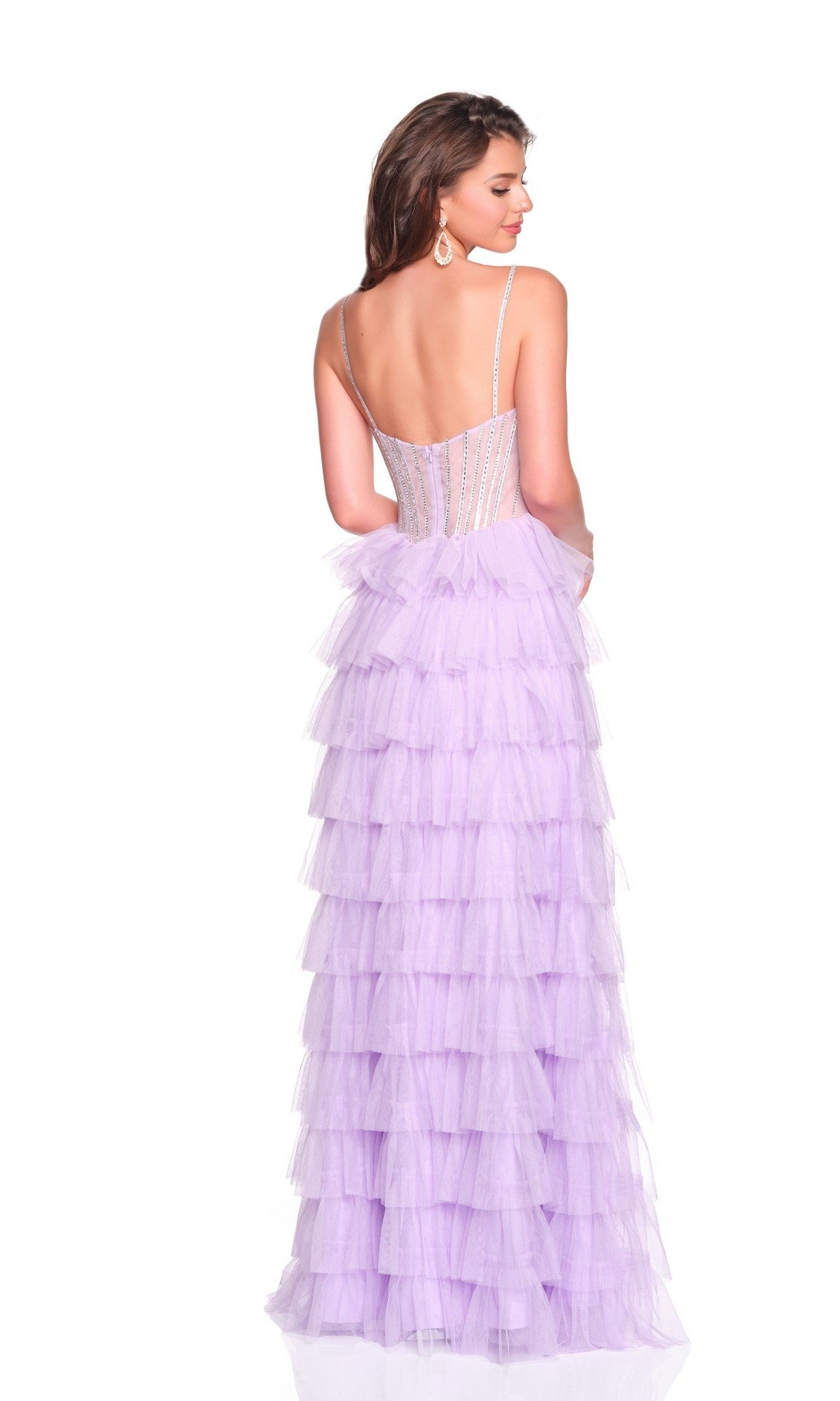 A woman stands facing away in the Dave and Johnny 12690 long prom dress—sleeveless, light purple, with a corset bodice, backless design, and tiered ruffled skirt.